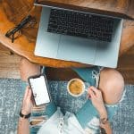 Picture of someone working on a computer with a coffee, from above - AUDE NERESTAN